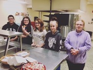 Students help others at the RFC by serving dinner.