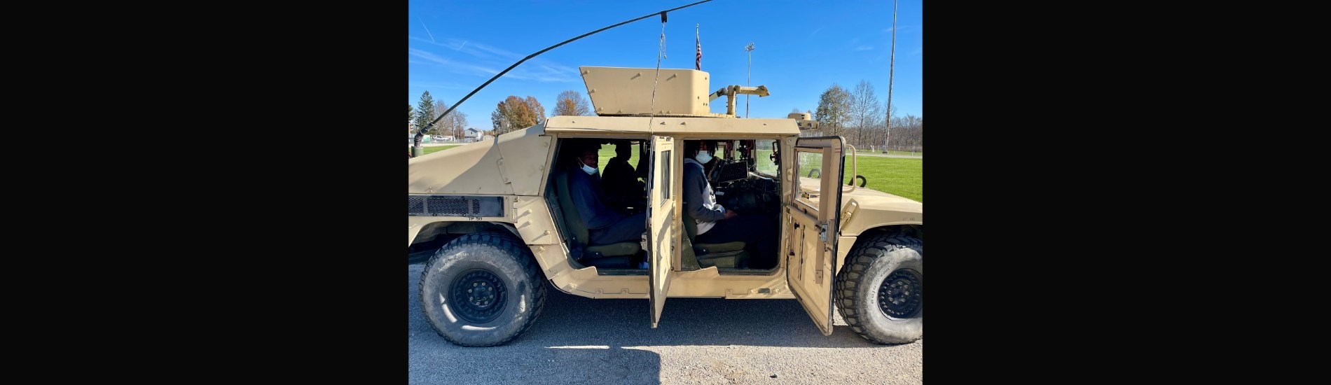 High school students in the humvee loaned by the Arsenal
