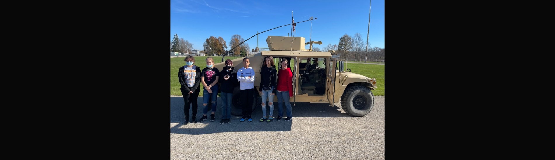8th graders standing near humvee loaned by the Arsenal