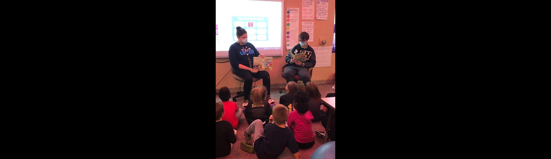 Windham High School students read to a group of elementary students.