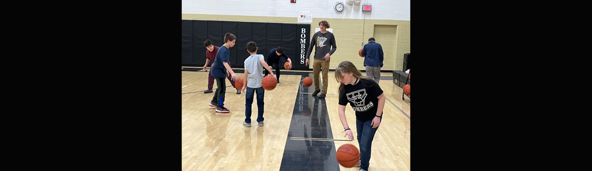 JH Students practice dribbling and ball handling skills in Bomber Time.